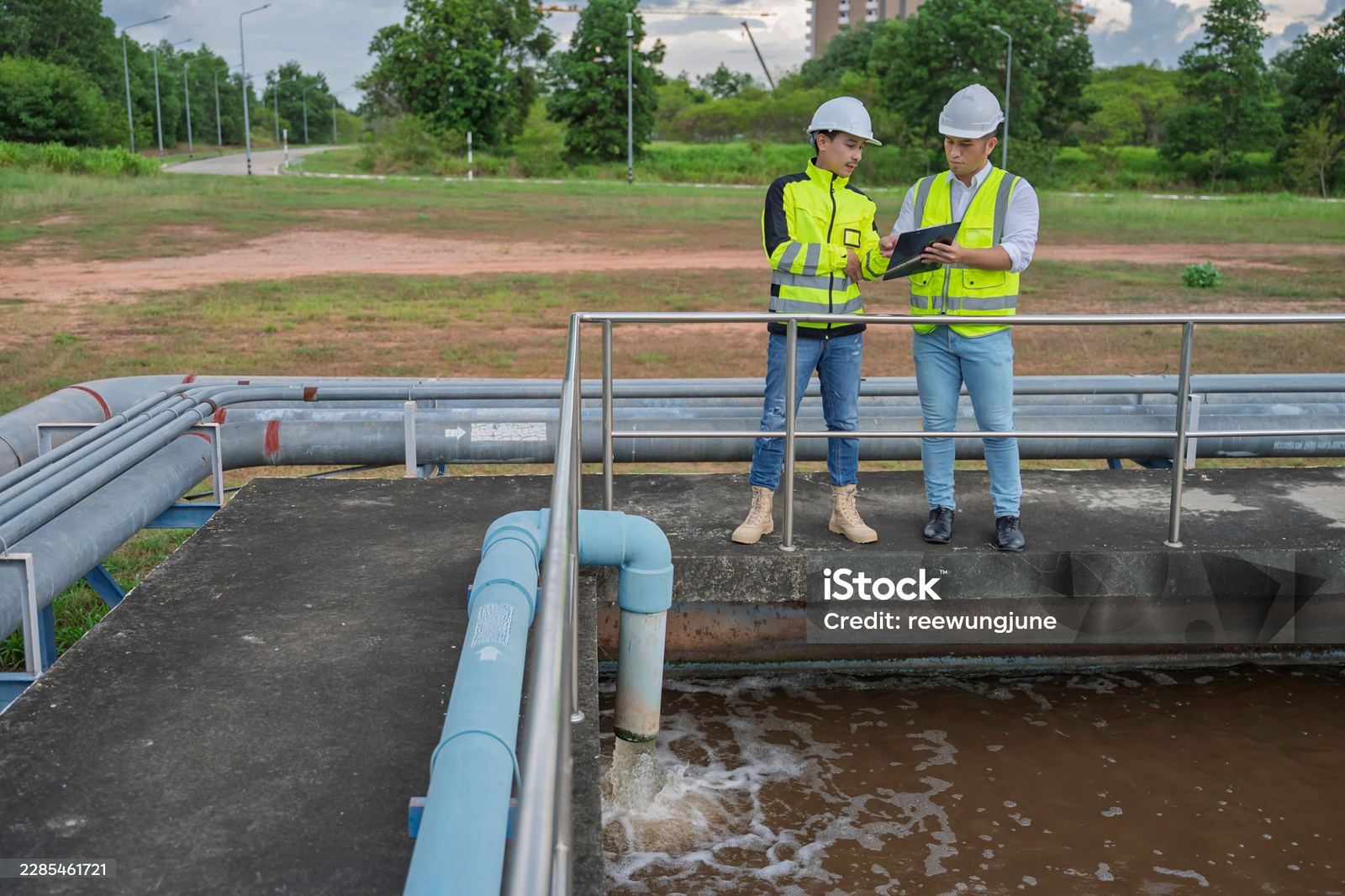 Hawkins-Weir engineers reviewing plans at a wastewater treatment site